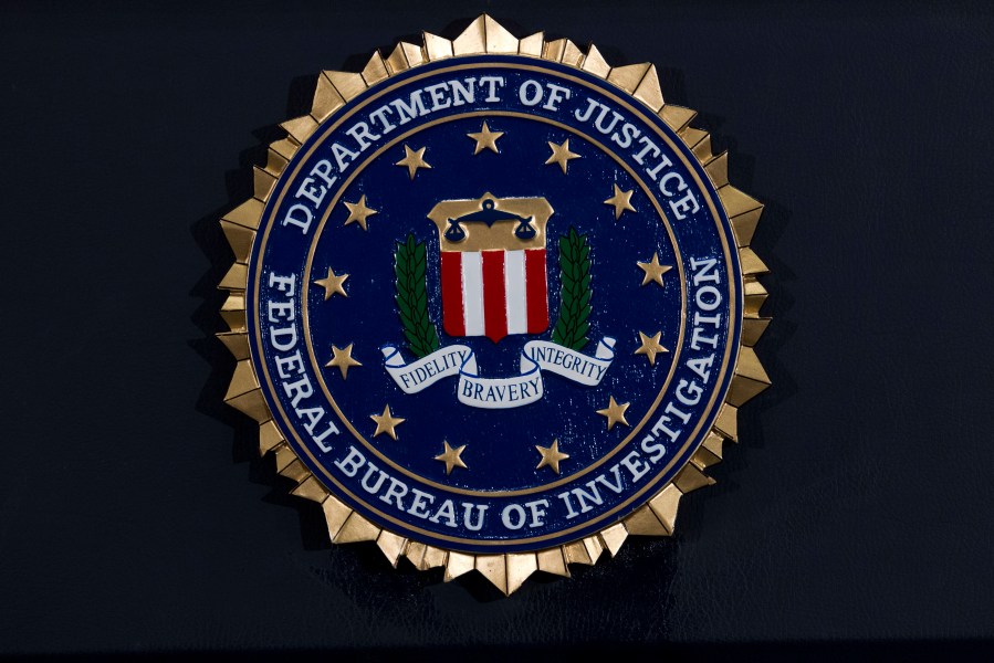 This Thursday, June 14, 2018, file photo, shows the FBI seal at a news conference at FBI headquarters in Washington.(AP Photo/Jose Luis Magana, File)