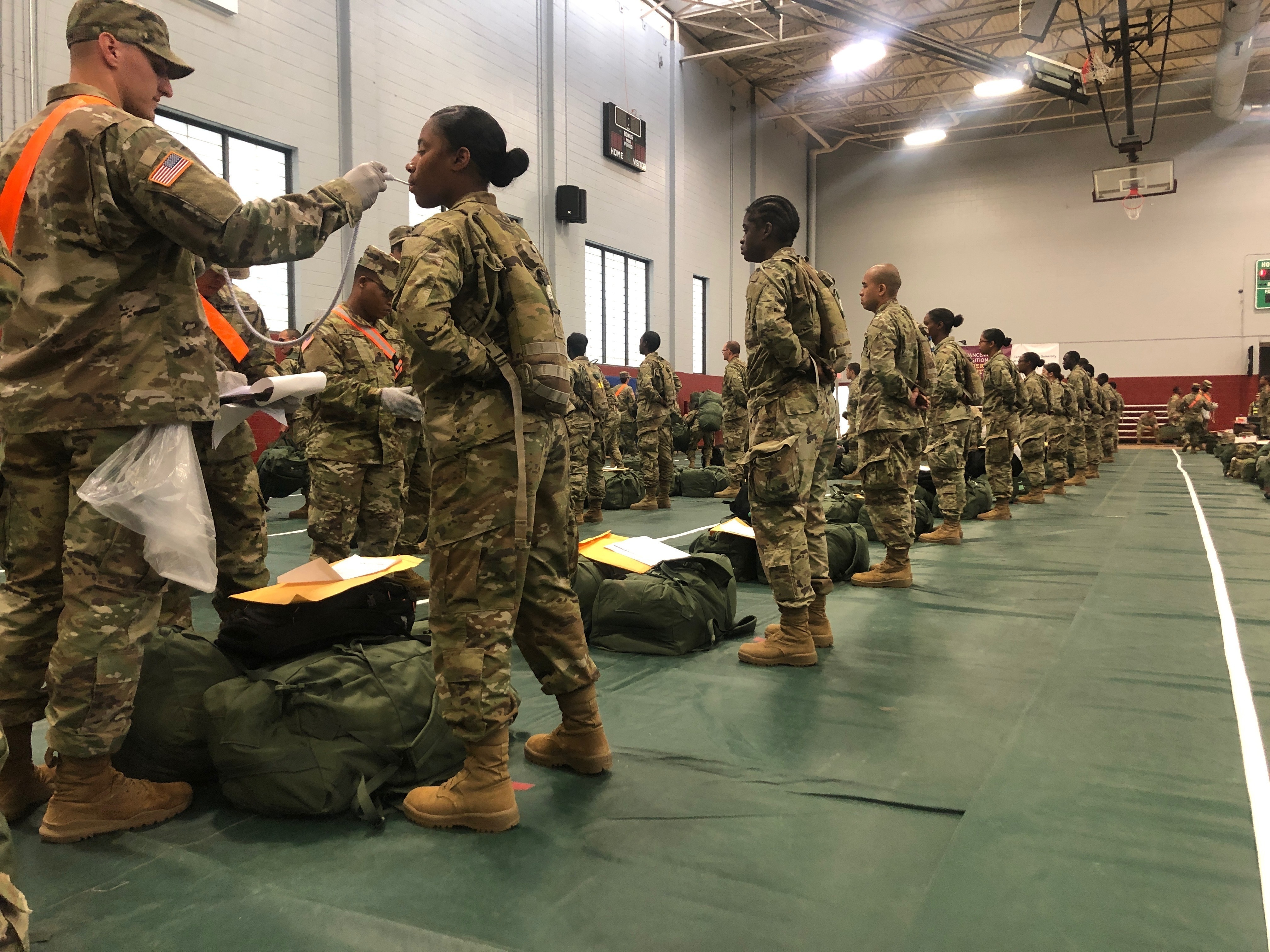 In this image provided by the U.S. Army, recent Army basic combat training graduates have their temperatures taken as they arrive at Fort Lee, Va, on March 31, 2020. (U.S. Army via AP)