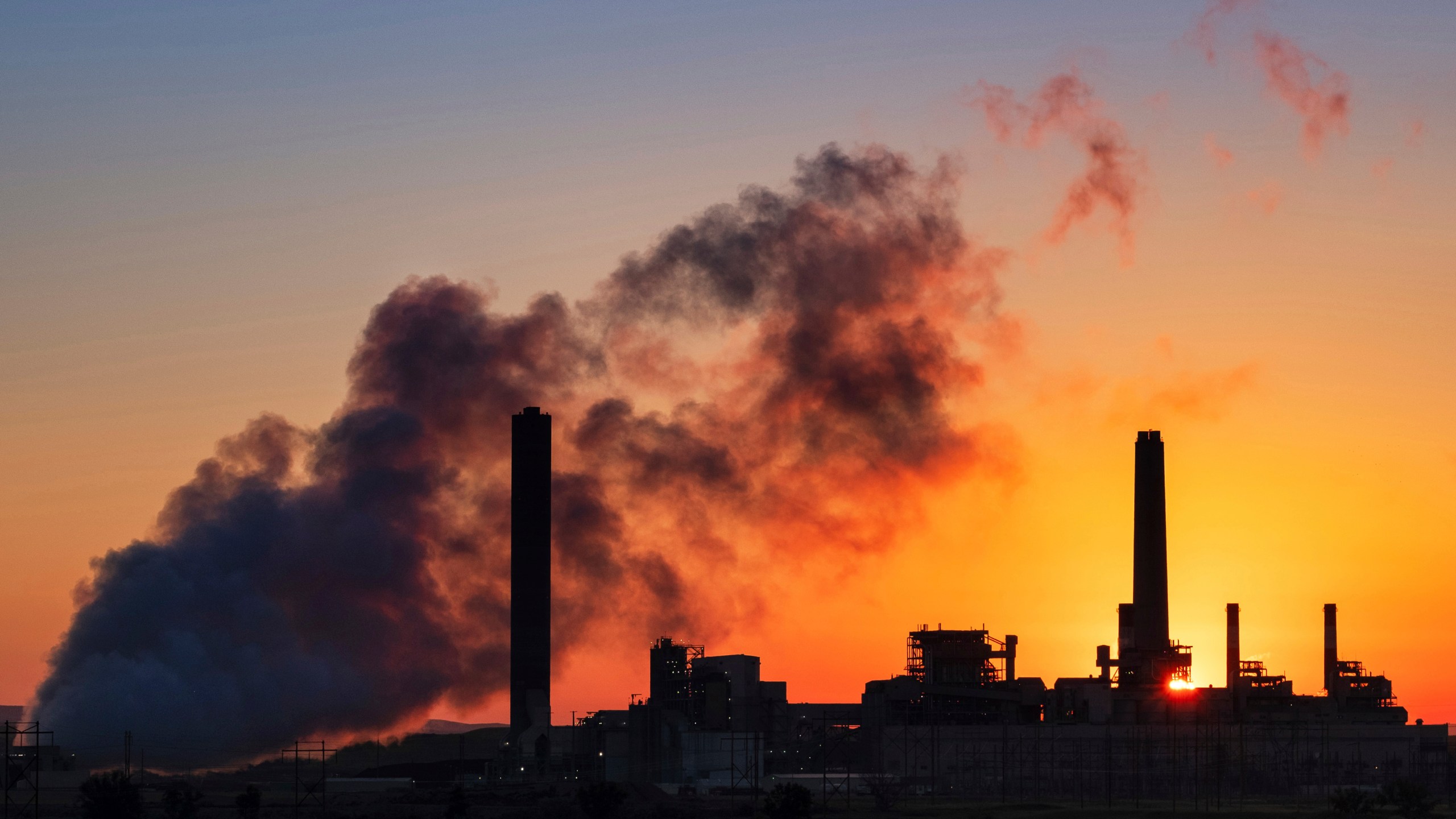 The Dave Johnson coal-fired power plant is silhouetted against the morning sun in Glenrock, Wyo., Friday, July 27, 2018. The Trump administration has weakened an Obama-era rule aimed at stopping coal plant pollution that has contaminated streams, lakes and underground aquifers. The changes finalized Monday, Aug. 31, 2020, will allow utilities to use cheaper wastewater cleanup technologies and take longer to comply with pollution reduction guidelines adopted in 2015. Its the latest in a string of regulatory rollbacks for the coal power industry under Trump. (AP Photo/J. David Ake, File)