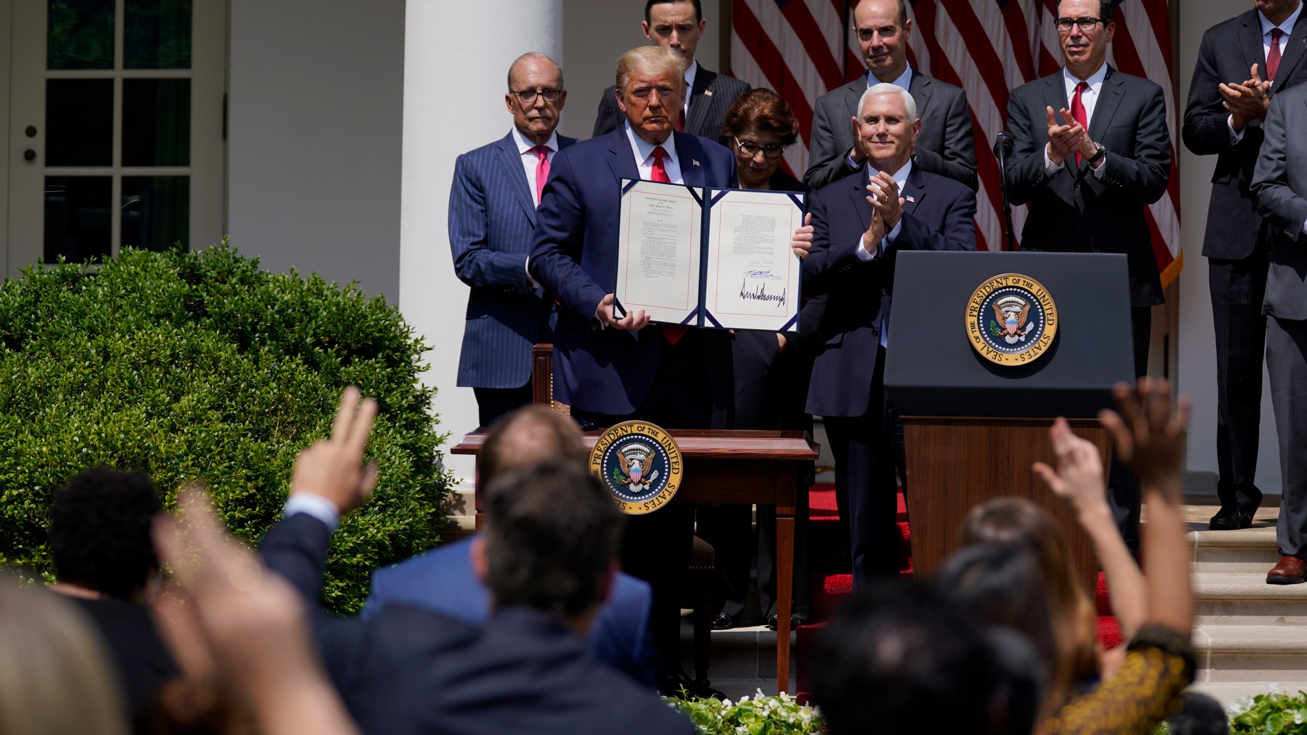 In this June 5, 2020 file photo, President Donald Trump poses for a photo after signing the Paycheck Protection Program Flexibility Act during a news conference in the Rose Garden of the White House in Washington. (AP Photo/Evan Vucci, File)