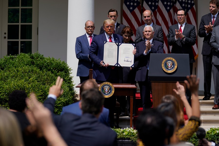 In this June 5, 2020 file photo, President Donald Trump poses for a photo after signing the Paycheck Protection Program Flexibility Act during a news conference in the Rose Garden of the White House in Washington. (AP Photo/Evan Vucci, File)