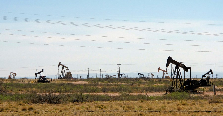 In this April 9, 2014, file photo, oil rigs stand in the Loco Hills field on U.S. Highway 82 in Eddy County near Artesia, N.M., one of the most active regions of the Permian Basin. President Joe Biden is set to announce a wide-ranging moratorium on new oil and gas leasing on U.S. lands, as his administration moves quickly to reverse Trump administration policies on energy and the environment and address climate change. (AP Photo/Jeri Clausing, File)