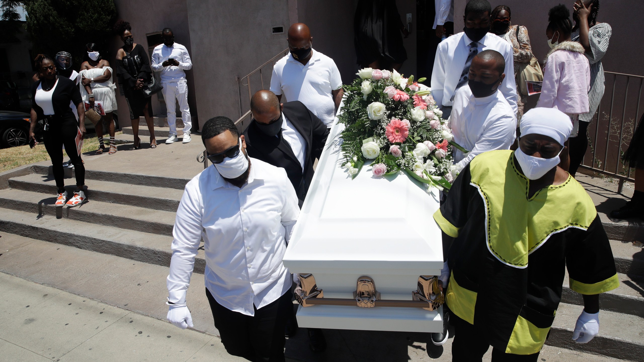 In this July 21, 2020 file photo Pall bearers carry a casket with the body of Lydia Nunez, who died from COVID-19, after a funeral service at the Metropolitan Baptist Church, in Los Angeles.(AP Photo/Marcio Jose Sanchez,File)