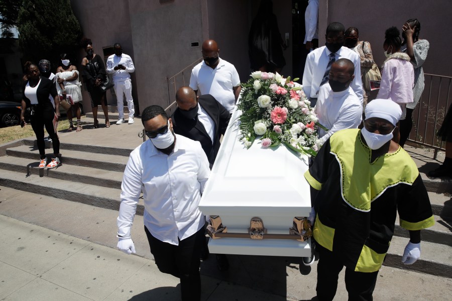 In this July 21, 2020 file photo Pall bearers carry a casket with the body of Lydia Nunez, who died from COVID-19, after a funeral service at the Metropolitan Baptist Church, in Los Angeles.(AP Photo/Marcio Jose Sanchez,File)