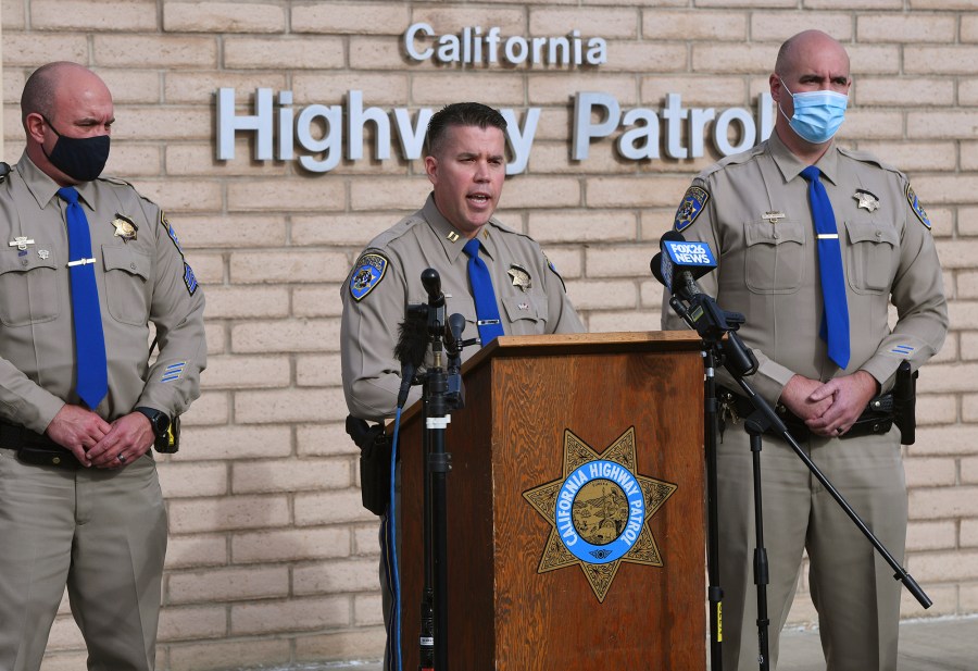 California Highway Patrol Captain Kevin Clays, center, updates the media about Friday's fatal crash on Highway 33 on Saturday, Jan. 2, 2021 in Coalinga, Calif.  (Eric Paul Zamora/The Fresno Bee via AP)