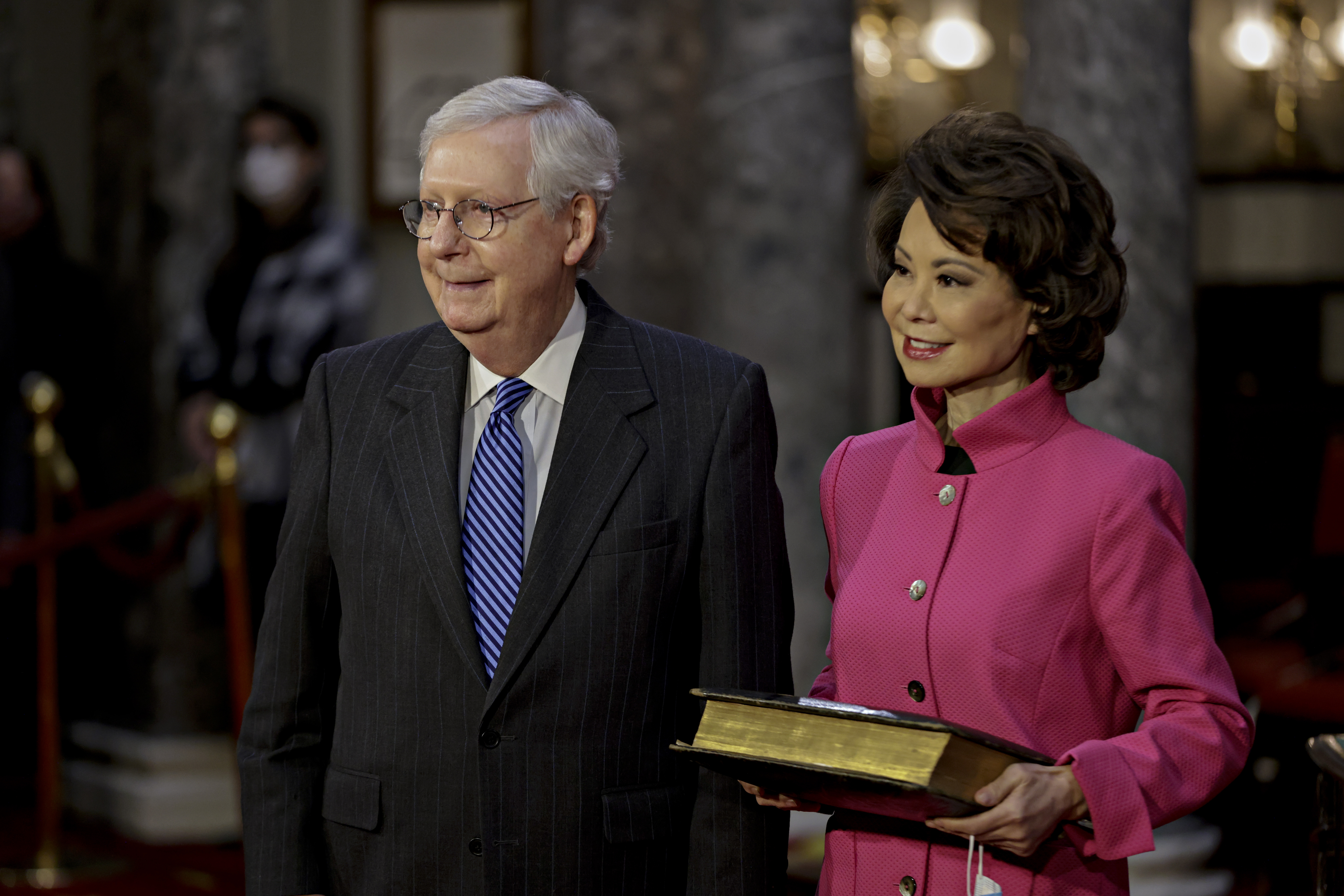 Sen. Mitch McConnell, R-Ky., and his wife Transportation Secretary Elaine Chao, wait for McConnell to be sworn in during a reenactment ceremony in the Old Senate Chamber at the Capitol in Washington, Jan. 3, 2021. (Samuel Corum/Pool via AP)