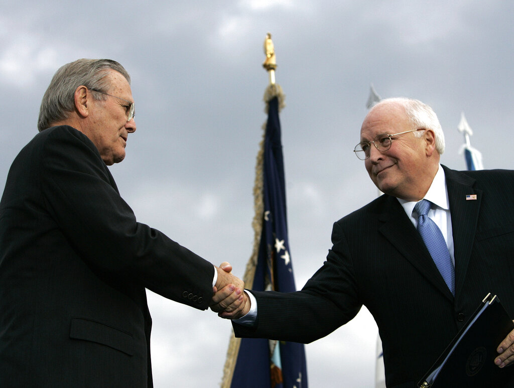 In this Dec. 15, 2006, file photo, outgoing Defense Secretary Donald H. Rumsfeld, left, shakes hands with Vice President Dick Cheney during an Armed Forces Full Honor Review for Rumsfeld at the Pentagon. (AP Photo/Pablo Martinez Monsivais, File)