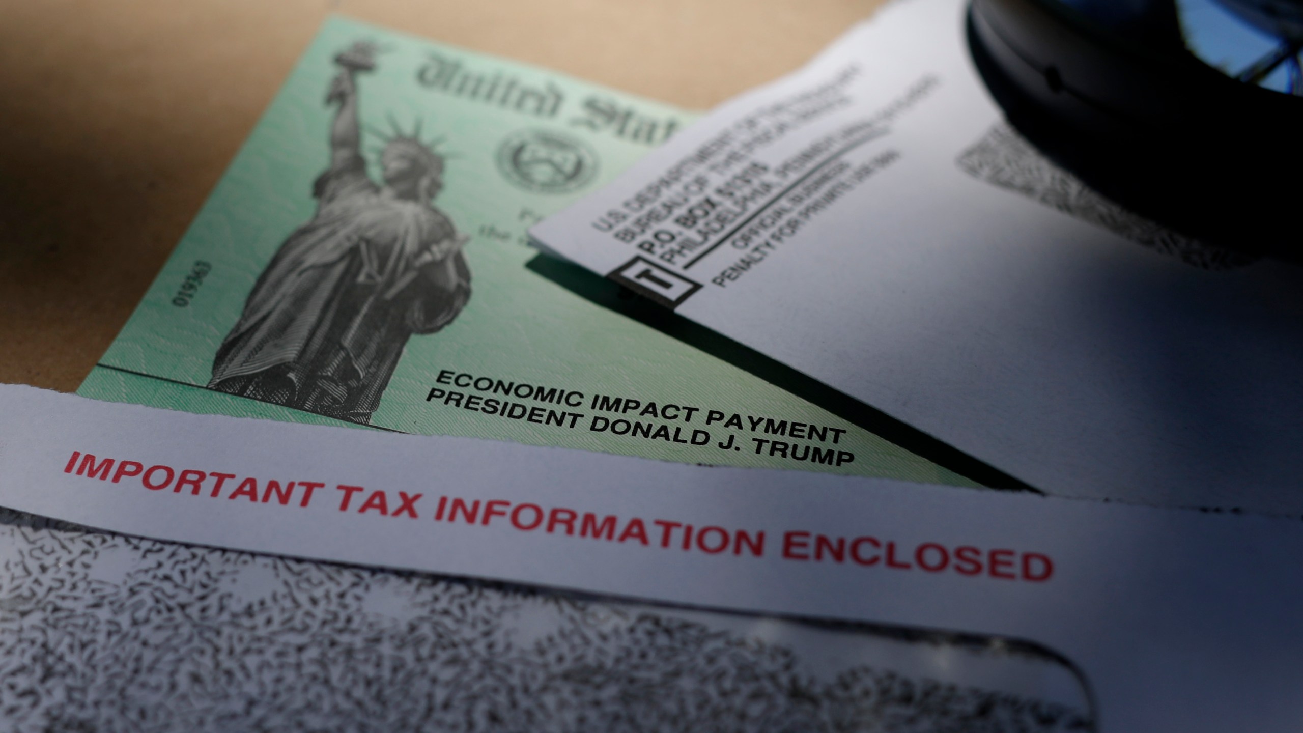 In this April 23, 2020, file photo, President Donald Trump's name is seen on a stimulus check issued by the IRS to help combat the adverse economic effects of the COVID-19 outbreak, in San Antonio. A number of taxpayers who use tax preparation services, such as H&R Block and TurboTax, say their second relief payments were sent to the incorrect bank account. The IRS and the Treasury Department began issuing the Economic Impact Payments last week of Jan. 1, 2021. (AP Photo/Eric Gay, File)