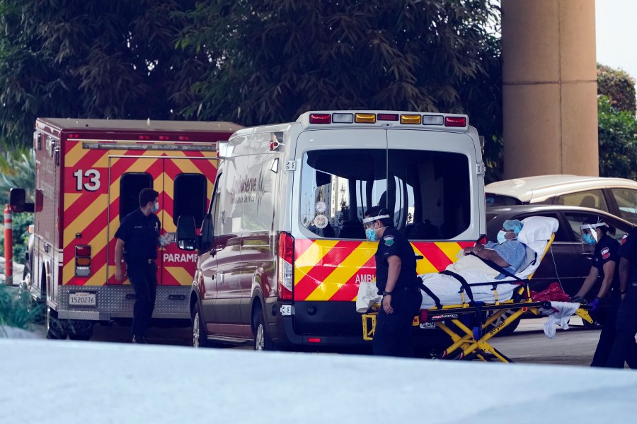 A patient is loaded onto an ambulance outside of the emergency entrance to PIH Health Good Samaritan Hospital Tuesday, Jan. 5, 2021, in Los Angeles. (Marcio Jose Sanchez/AP Photo)