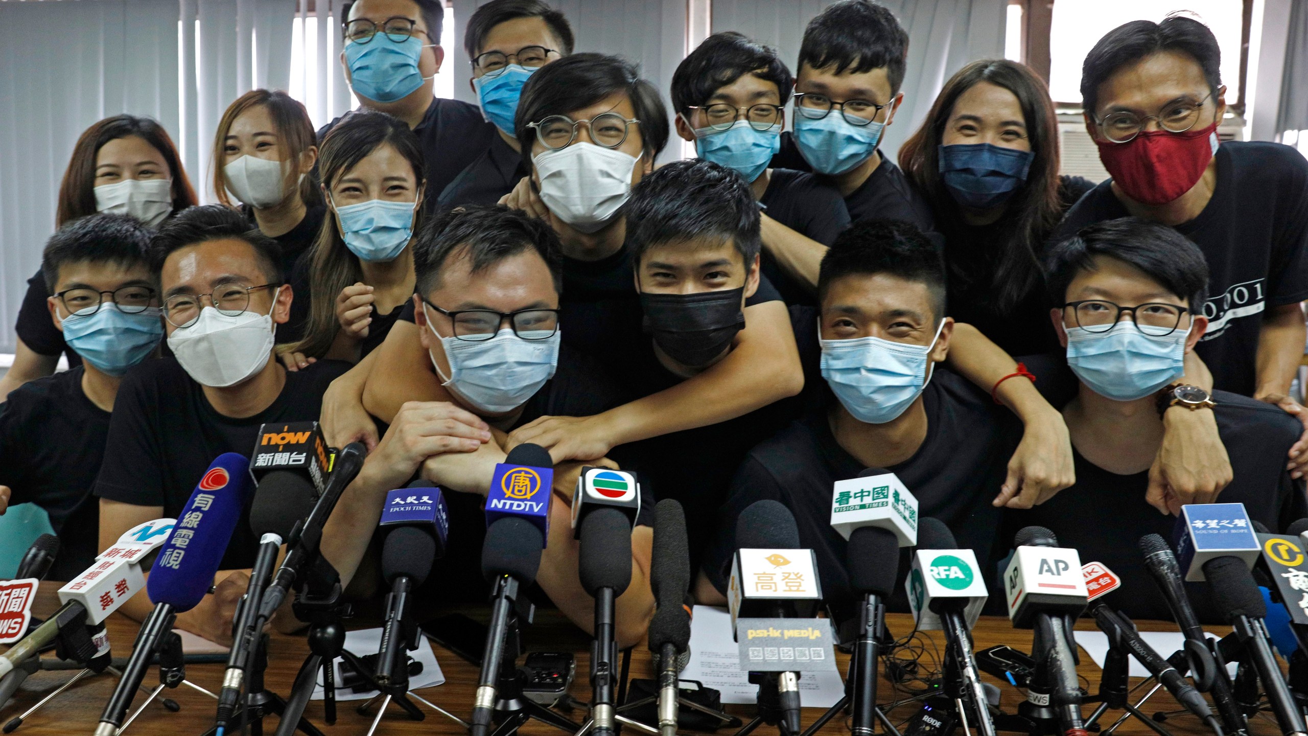 In this July 15, 2020, file photo, pro-democracy activists who were elected from unofficial pro-democracy primaries, including Joshua Wong, left, attend a press conference in Hong Kong. (Kin Cheung/AP Photo)