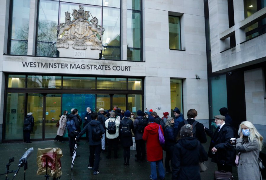 Julian Assange supporters and members of the media queue up outside Westminster Magistrates Court to get a seat at his Bail hearing in London, Wednesday, Jan. 6, 2021. (AP Photo/Matt Dunham)