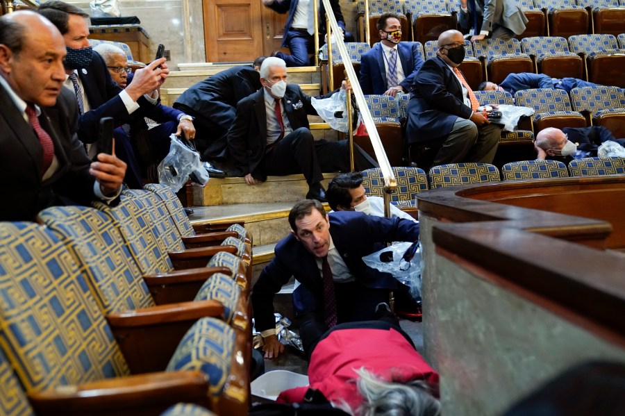 People shelter in the House gallery as protesters try to break into the House Chamber at the U.S. Capitol on Wednesday, Jan. 6, 2021, in Washington. (Andrew Harnik/AP Photo)People shelter in the House gallery as protesters try to break into the House Chamber at the U.S. Capitol on Wednesday, Jan. 6, 2021, in Washington. (Andrew Harnik/AP Photo)