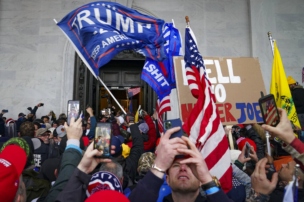 Trump supporters gather outside the Capitol, Wednesday, Jan. 6, 2021, in Washington. (AP Photo/John Minchillo)