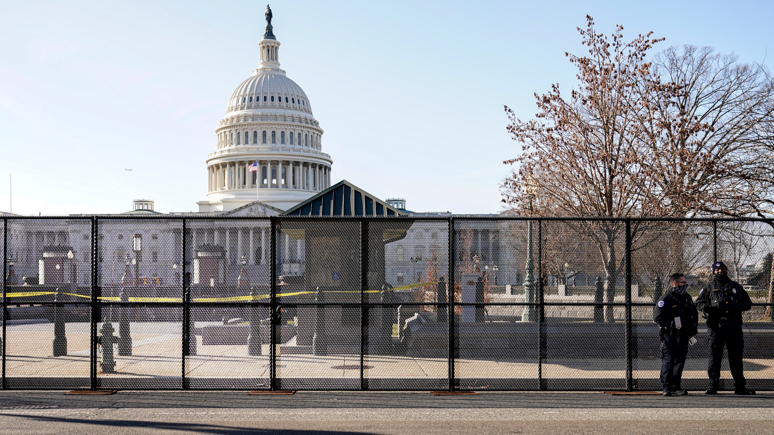 Capitol police officers stand outside of fencing that was installed around the exterior of the Capitol grounds on Jan. 7, 2021, in Washington. (AP Photo/John Minchillo)