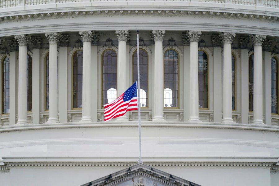 An American flag flies at half-staff in remembrance of U.S. Capitol Police Officer Brian Sicknick above the Capitol Building in Washington, Friday, Jan. 8, 2021. Sicknick died from injuries sustained as President Donald Trump's supporters stormed the Capitol. (AP Photo/Patrick Semansky)