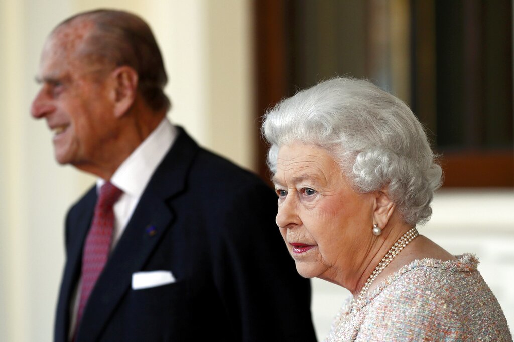 In this Thursday, Nov. 3, 2016 file photo, Britain's Prince Philip and Queen Elizabeth II are seen at Buckingham Palace in London. (Stefan Wermuth/Pool Photo via AP, File)