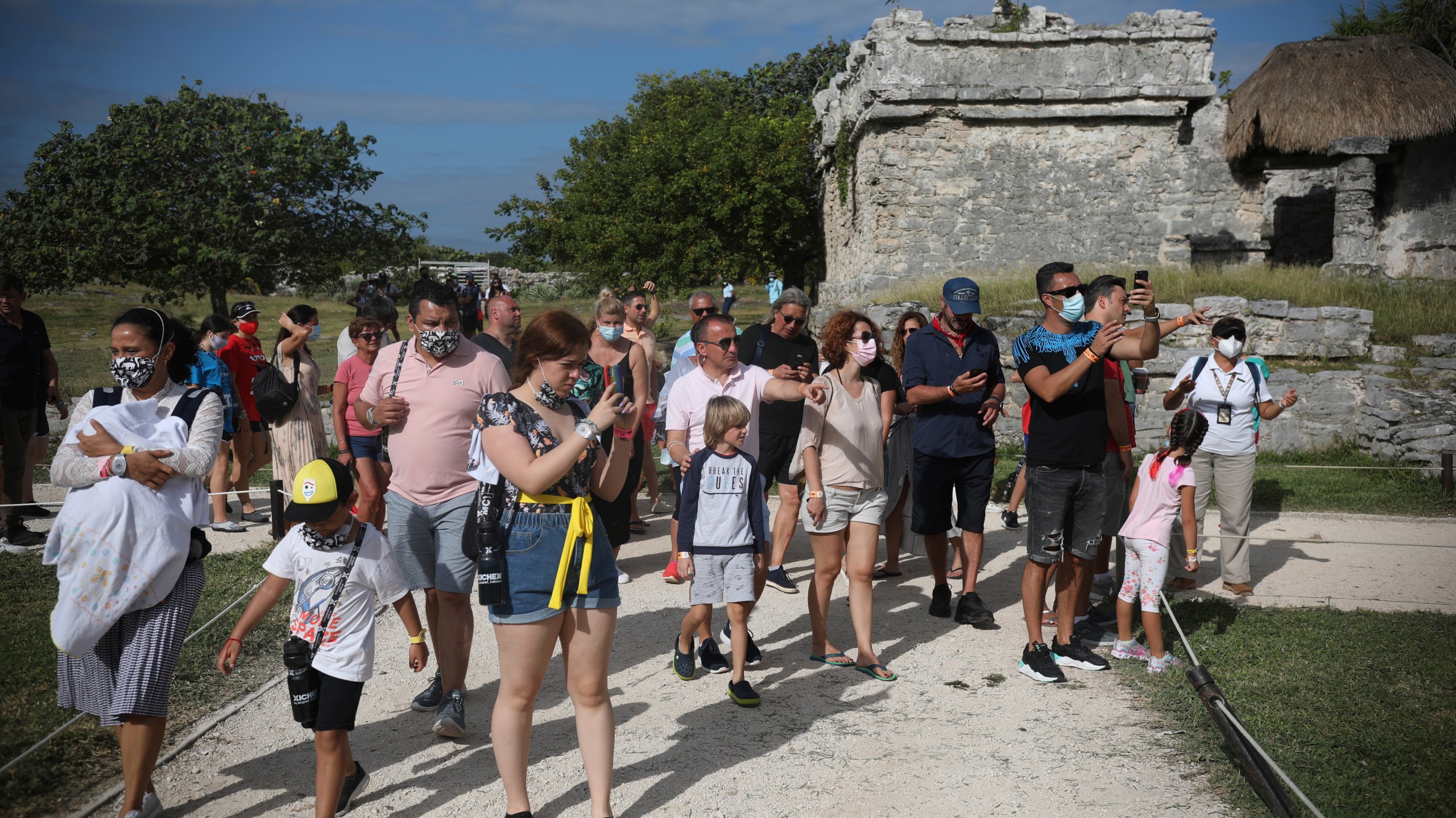 Tourists, required to wear protective face masks amid the coronavirus pandemic, visit the Mayan ruins of Tulum in Quintana Roo state, Mexico Jan. 5, 2021. (Emilio Espejel/Associated Press)