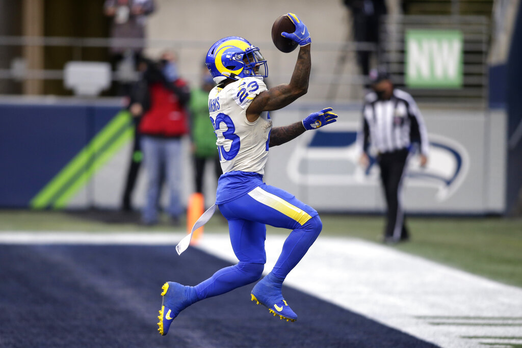 Los Angeles Rams running back Cam Akers reacts after scoring on a 5-yard run against the Seattle Seahawks during the first half of an NFL wild-card playoff football game on Jan. 9, 2021, in Seattle. (AP Photo/Scott Eklund)