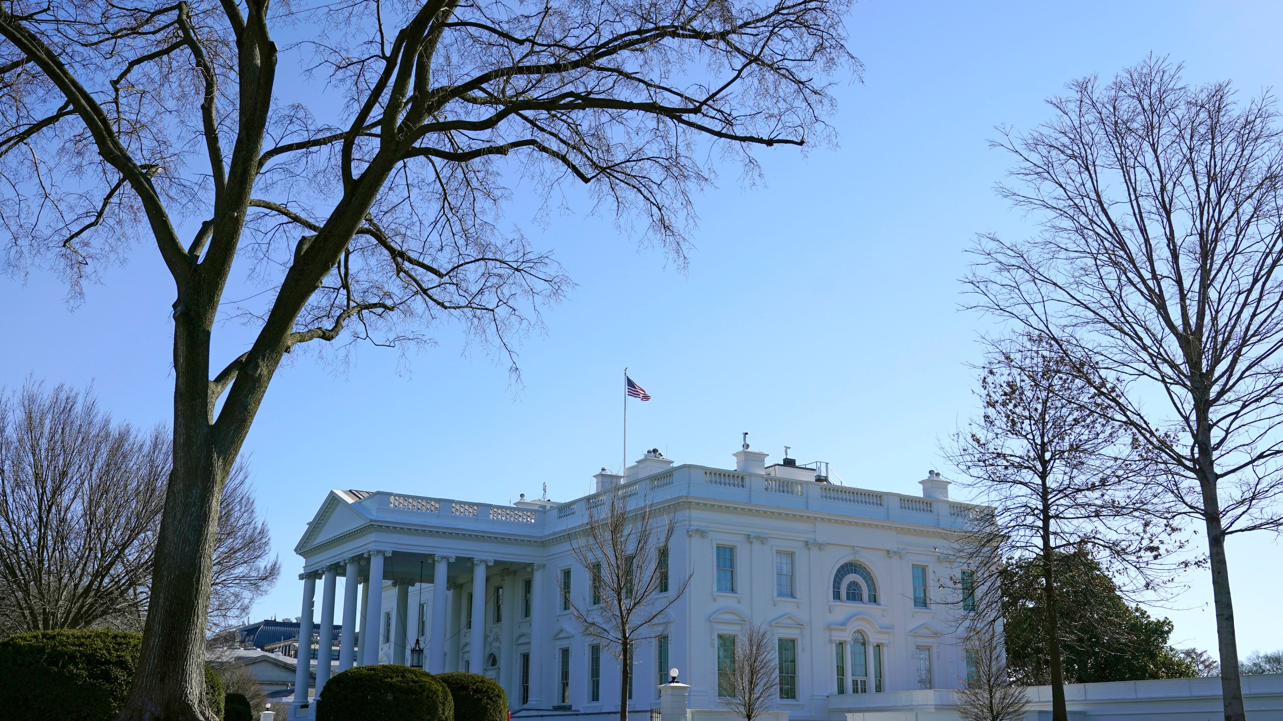 An American flag flies above the White House in Washington, Sunday, Jan. 10, 2021. (AP Photo/Patrick Semansky)