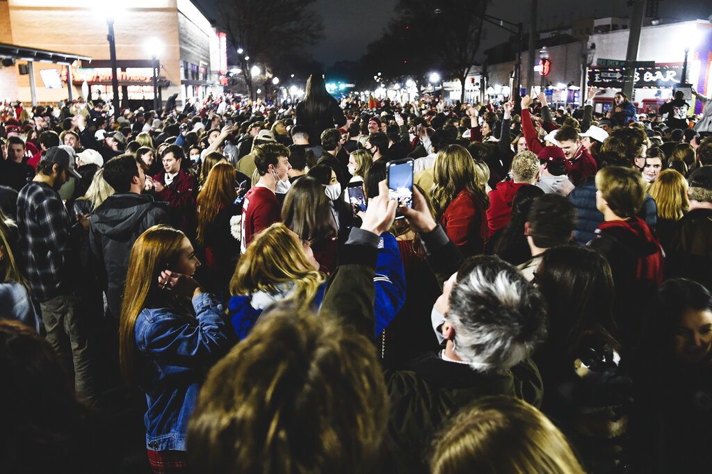 Alabama fans celebrate in the street in Tuscaloosa, Ala., Monday night, Jan. 11, 2021, after Alabama defeated Ohio State 52-24 in the NCAA college football national championship game in Miami Gardens, Fla. (Benjamin Flanagan/Alabama Media Group via AP)