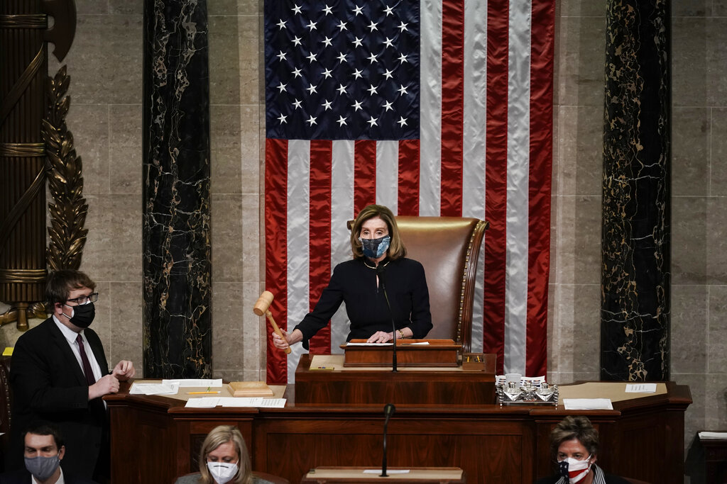 Speaker of the House Nancy Pelosi, D-Calif., leads the final vote of the impeachment of President Donald Trump, for his role in inciting an angry mob to storm the Congress last week, at the Capitol in Washington, Wednesday, Jan. 13, 2021. (AP Photo/J. Scott Applewhite)