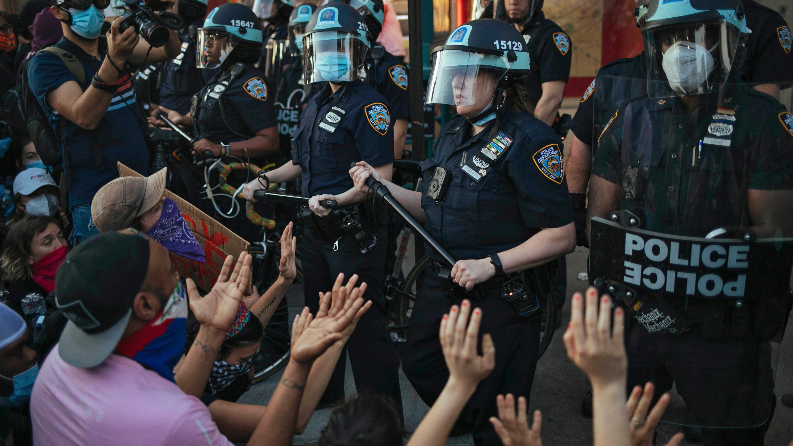 FILE - This May 31, 2020 file photo shows New York City Police facing off with activists during a protest march in the Bedford-Stuyvesant section of the Brooklyn borough of New York. New York’s attorney general sued the New York Police Department on Thursday, Jan. 14, 2021 alleging the rough treatment of protesters last spring in the wake of George Floyd’s killing was part of a longstanding pattern of abuse that stemmed from inadequate training, supervision and discipline. (AP Photo/Kevin Hagen, FIle)