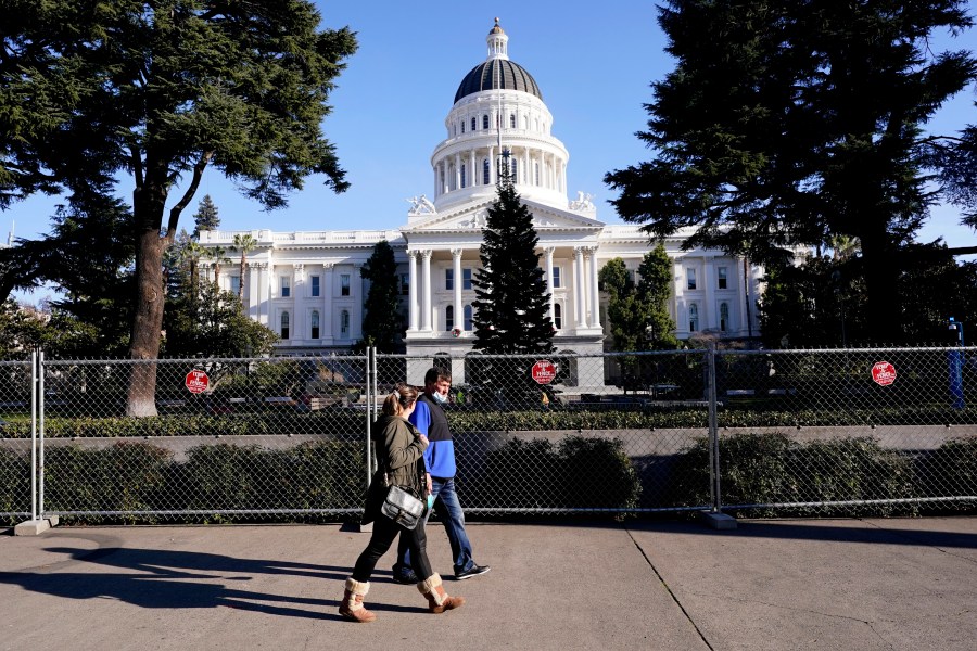 A temporary six-foot high chain link fence surrounds the state Capitol because of concerns over the potential for civil unrest, in Sacramento, Calif., Thursday, Jan. 14, 2021. (AP Photo/Rich Pedroncelli)