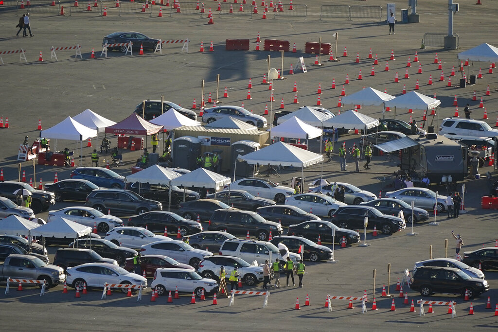 Motorists line up at a COVID-19 vaccination site at Dodger Stadium Jan. 15, 2021, in Los Angeles. (AP Photo/Marcio Jose Sanchez)