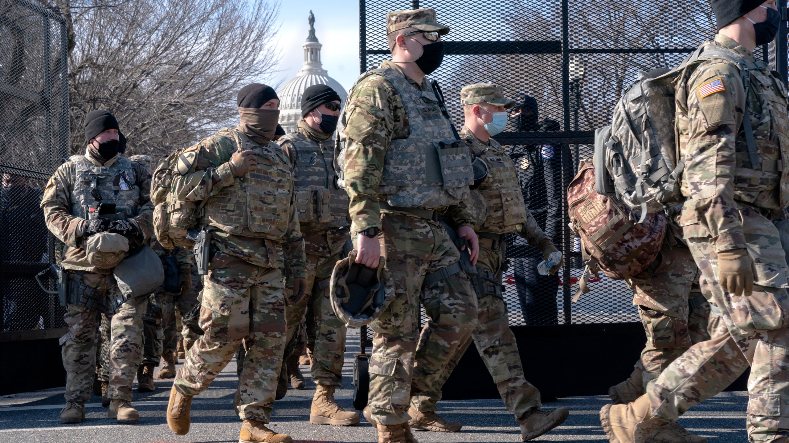 With the U.S. Capitol in the background, members of the National Guard change shifts as they exit through anti-scaling security fencing on Saturday, Jan. 16, 2021, in Washington as security is increased ahead of the inauguration of President-elect Joe Biden and Vice President-elect Kamala Harris. (AP Photo/Jacquelyn Martin)