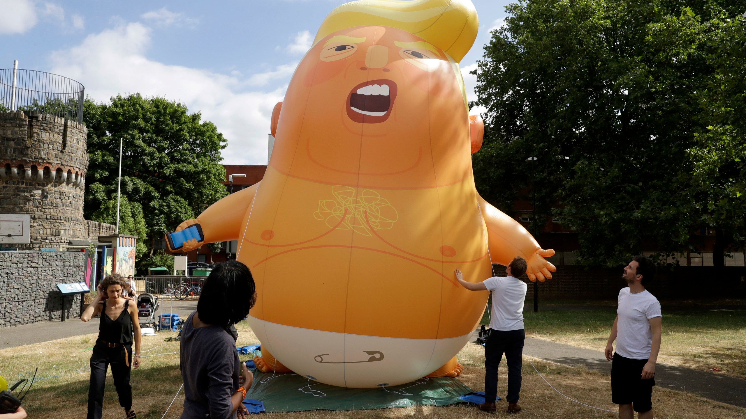 In this file photo taken Tuesday, July 10, 2018, a six-meter high cartoon baby blimp depicting U.S. President Donald Trump in north London. (AP Photo/Matt Dunham, FILE)