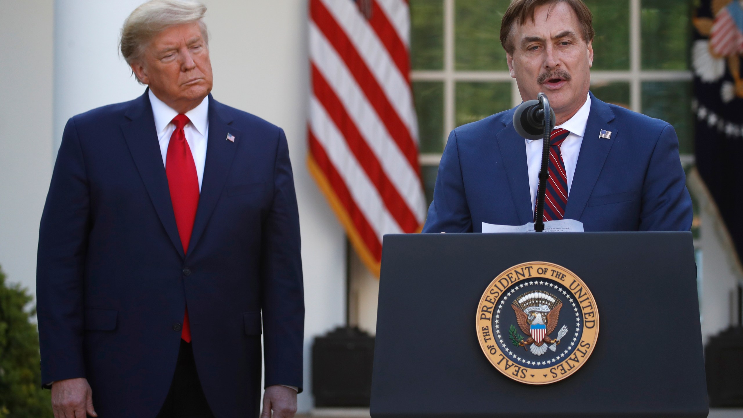 In this March 30, 2020 file photo, My Pillow CEO Mike Lindell speaks as President Donald Trump listens during a briefing about the coronavirus in the Rose Garden of the White House, in Washington. (AP Photo/Alex Brandon, File)