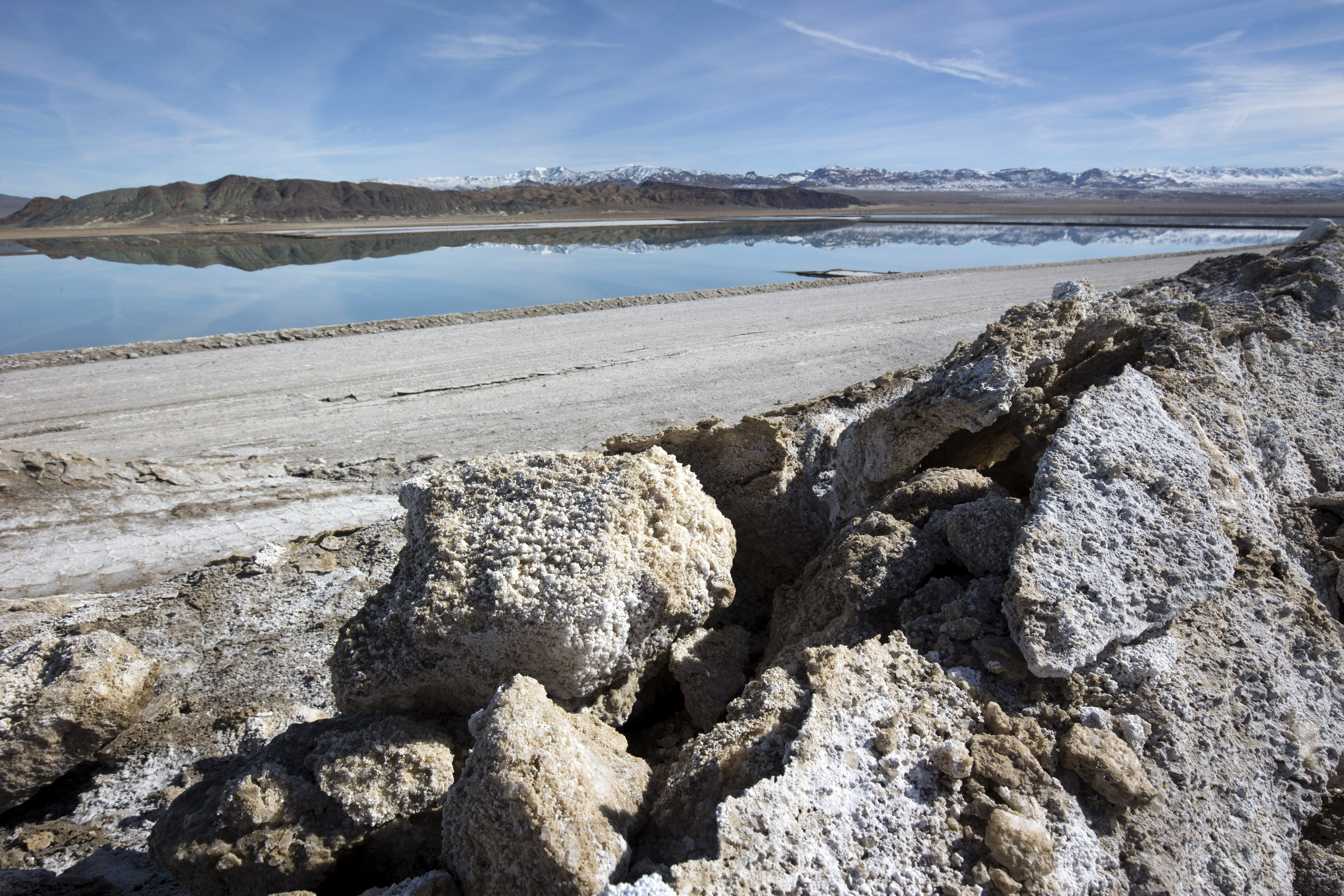 In this Jan. 30, 2017, file photo, waste salt, foreground, is shown near an evaporation pond at the Silver Peak lithium mine near Tonopah, Nev. (Steve Marcus/Las Vegas Sun via AP)