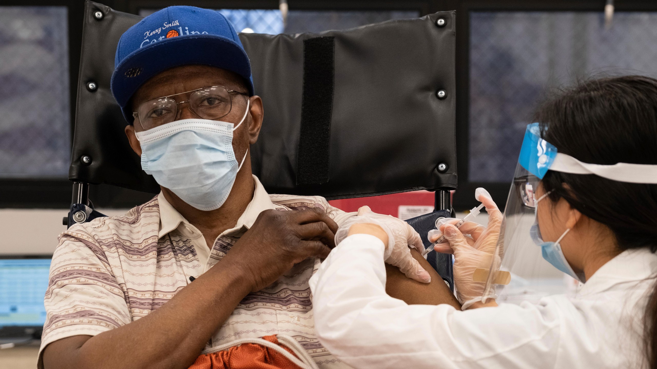 In this Jan. 15, 2021, file photo, a nursing home resident receives the COVID-19 vaccine by a CVS Pharmacist at Harlem Center for Nursing and Rehabilitation, a nursing home facility in Harlem neighborhood of New York. The push to inoculate Americans against the coronavirus is hitting a roadblock: A number of states are reporting they are running out of vaccine, and tens of thousands of people who managed to get appointments for a first dose are seeing them canceled. (AP Photo/Yuki Iwamura)