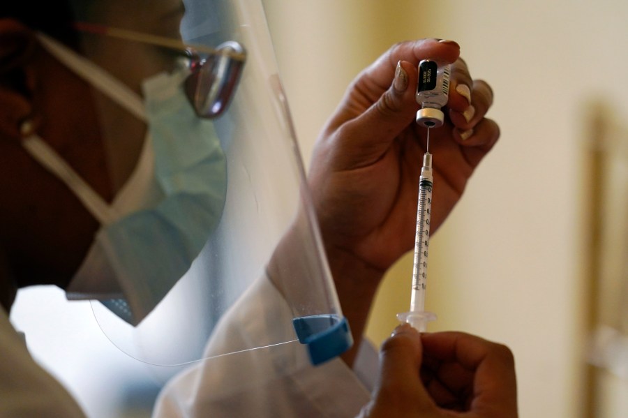 In this Tuesday, Jan. 12, 2021, file photo, a Walgreens pharmacist prepares a syringe with the Pfizer-BioNTech COVID-19 vaccine for residents and staff at the The Palace assisted living facility in Coral Gables, Fla. (AP Photo/Lynne Sladky)