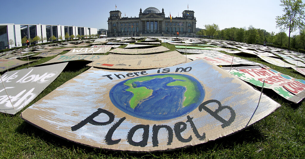 In this Friday, April 24, 2020 file photo, activists place thousands of protest placards in front of the Reichstag building, home of the german federal parliament, Bundestag, during a protest rally of the 'Fridays for Future' movement in Berlin, Germany. (AP Photo/Michael Sohn, File)