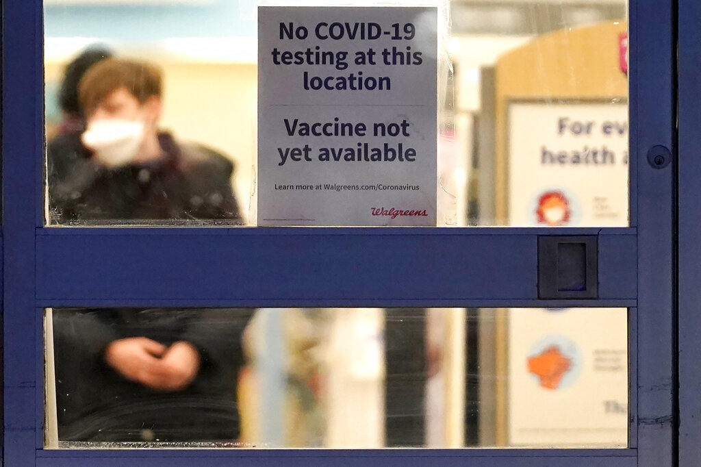 In this Jan. 16, 2021, file photo, a sign saying that a COVID-19 vaccine is not yet available hangs at Walgreens in Glenview, Ill. (AP Photo/Nam Y. Huh, File)