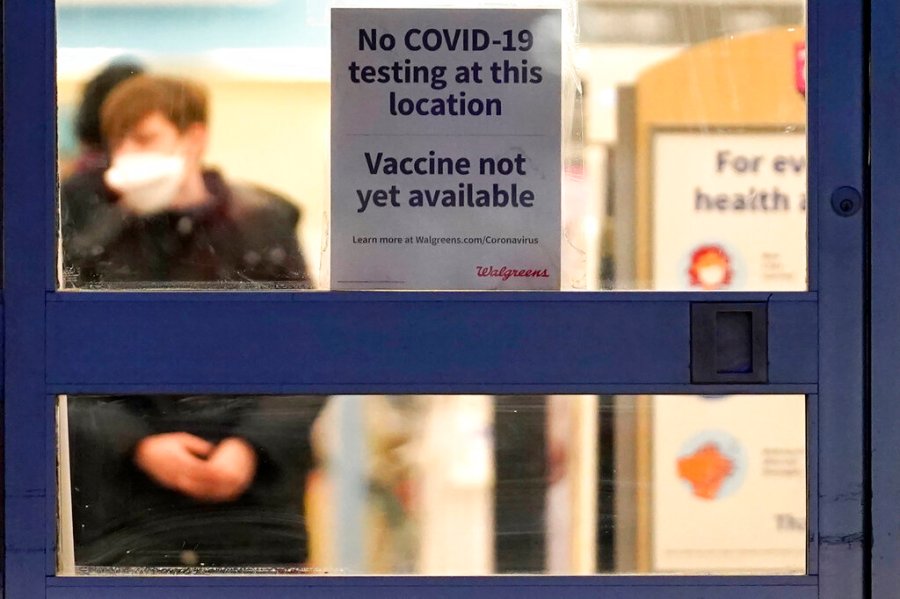 In this Jan. 16, 2021, file photo, a sign saying that a COVID-19 vaccine is not yet available hangs at Walgreens in Glenview, Ill. (AP Photo/Nam Y. Huh, File)