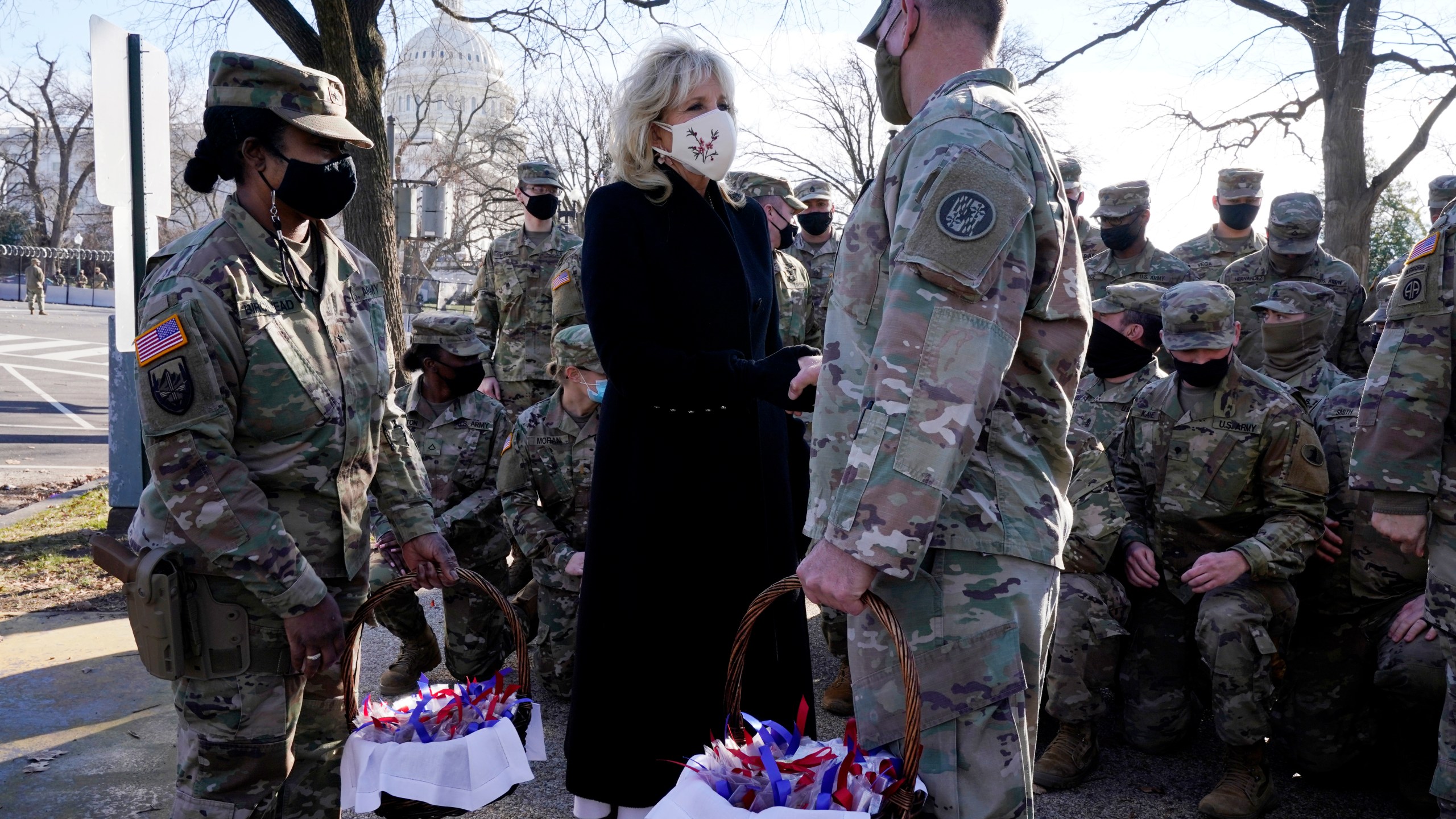 First lady Jill Biden surprises National Guard members outside the Capitol with chocolate chip cookies, Friday, Jan. 22, 2021, in Washington. (AP Photo/Jacquelyn Martin, Pool)