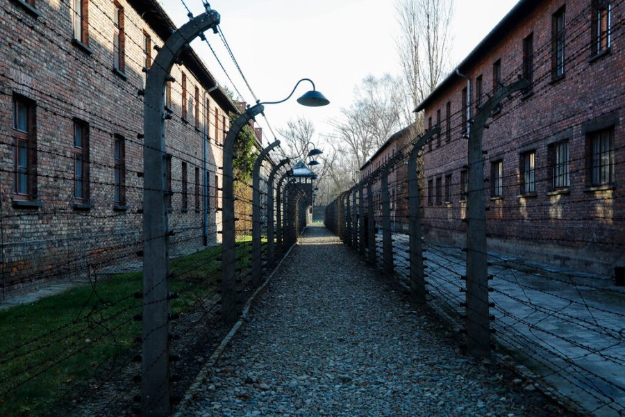 A pathway leading to an observation and security tower between what were electric barbed wire fences inside the former Nazi death camp of Auschwitz I in Oswiecim, Poland, Sunday, Dec. 8, 2019. (AP Photo/Markus Schreiber)