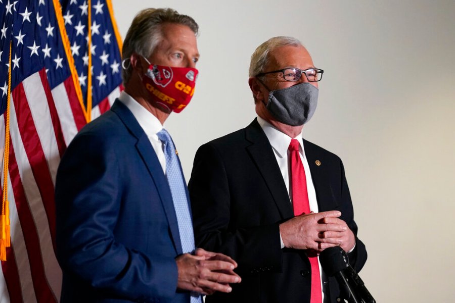 Sen. Roger Marshall, R-Kan., and Sen. Kevin Cramer, R-N.D., talk with reporters before a Republican policy luncheon on Capitol Hill in Washington, Tuesday, Jan. 26, 2021. (AP Photo/Susan Walsh)