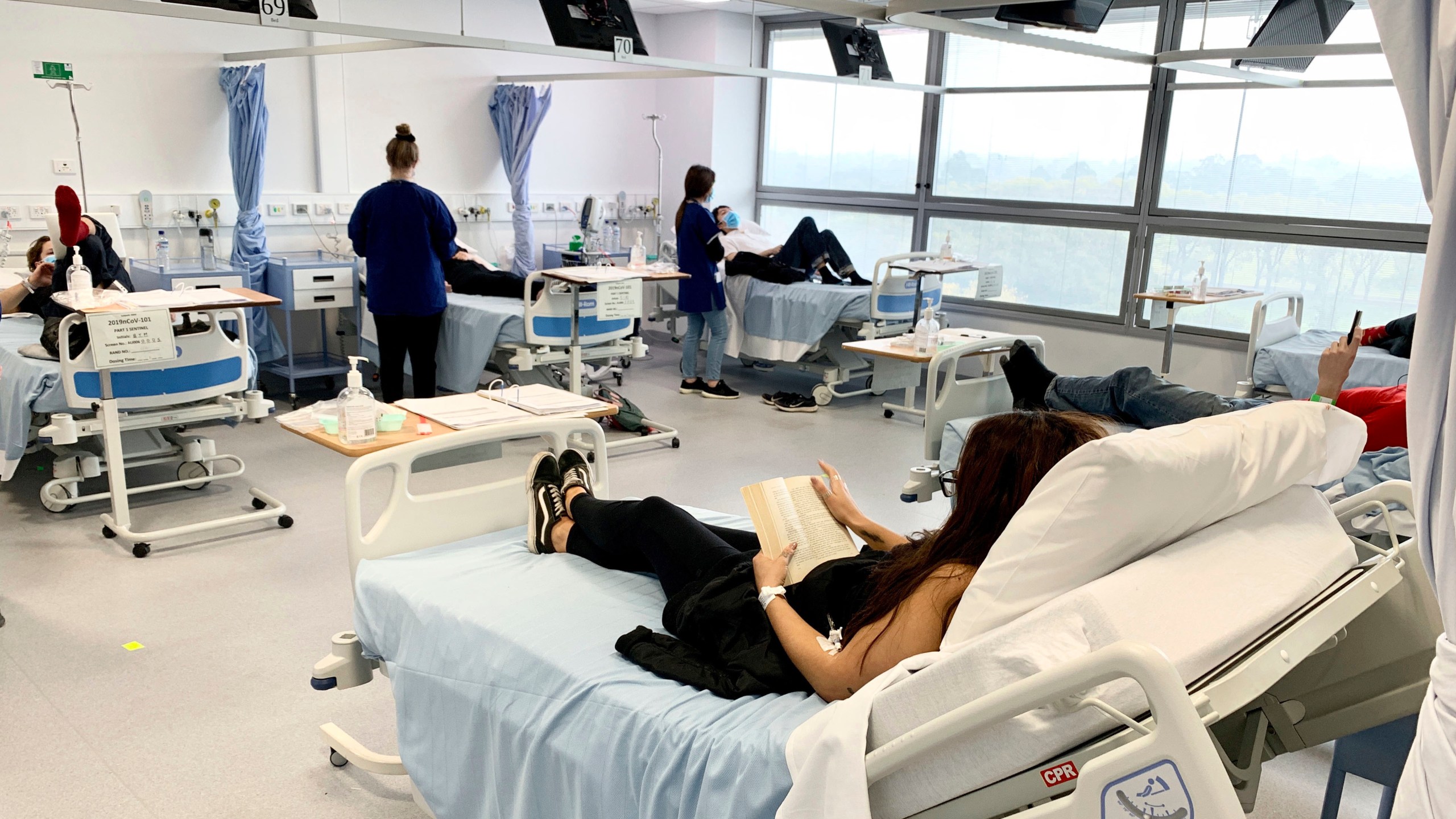 Clinical trial participants are monitored during Novavax COVID-19 vaccine testing in Melbourne, Australia, in this Tuesday, May 26, 2020 photo released by Nucleus Network/ABC. (Patrick Rocca / Nucleus Network / ABC via Associated Press)