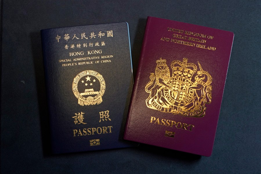 A British National Overseas passports (BNO) and a Hong Kong Special Administrative Region of the People's Republic of China passport are pictured in Hong Kong, Friday, Jan. 29, 2021. (AP Photo/Kin Cheung)