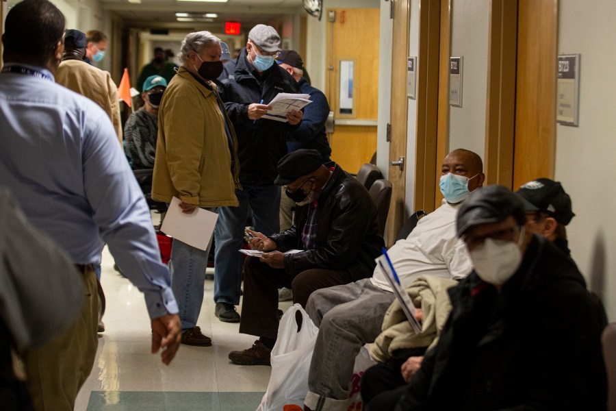 In this Jan. 23, 2021, file photo, veterans wait in line inside the VA Medical Center in Philadelphia to receive the COVID-19 vaccine during a walk-in clinic. (Tyger Williams/The Philadelphia Inquirer via AP)