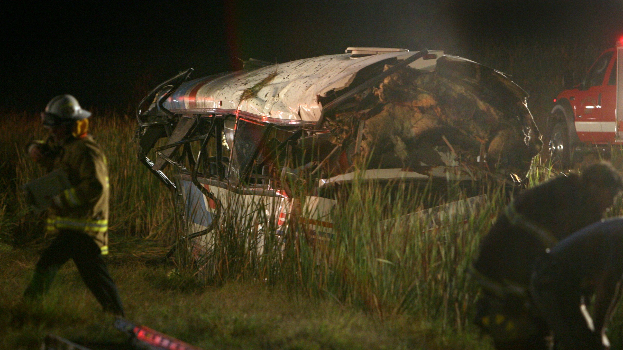 In this Oct. 5, 2008, file photo, a tour bus lies in a water filled ditch after crashing on a rural two lane road near Williams, Calif. The private bus crashed and killed 11 passengers headed to a Northern California casino. (AP Photo/Steve Yeater, File)