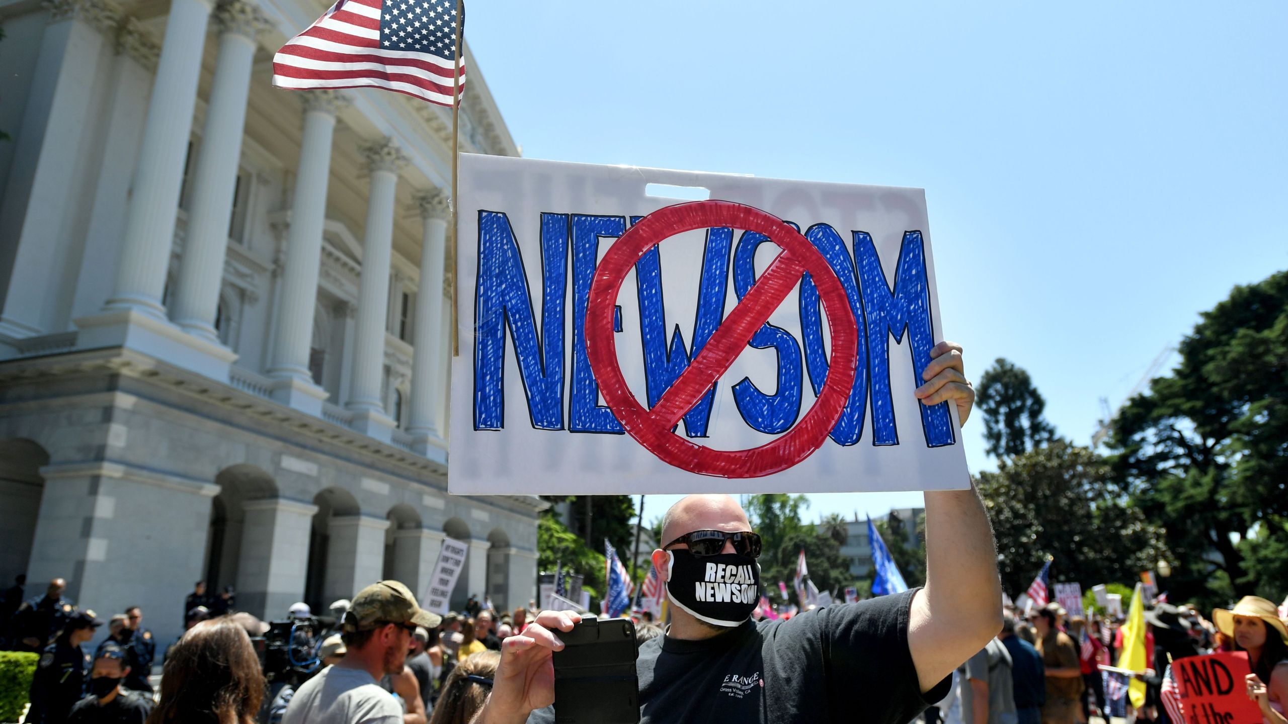 People gather to protest the stay-at-home orders outside the state capitol building in Sacramento, California on May 1, 2020. (JOSH EDELSON/AFP via Getty Images)