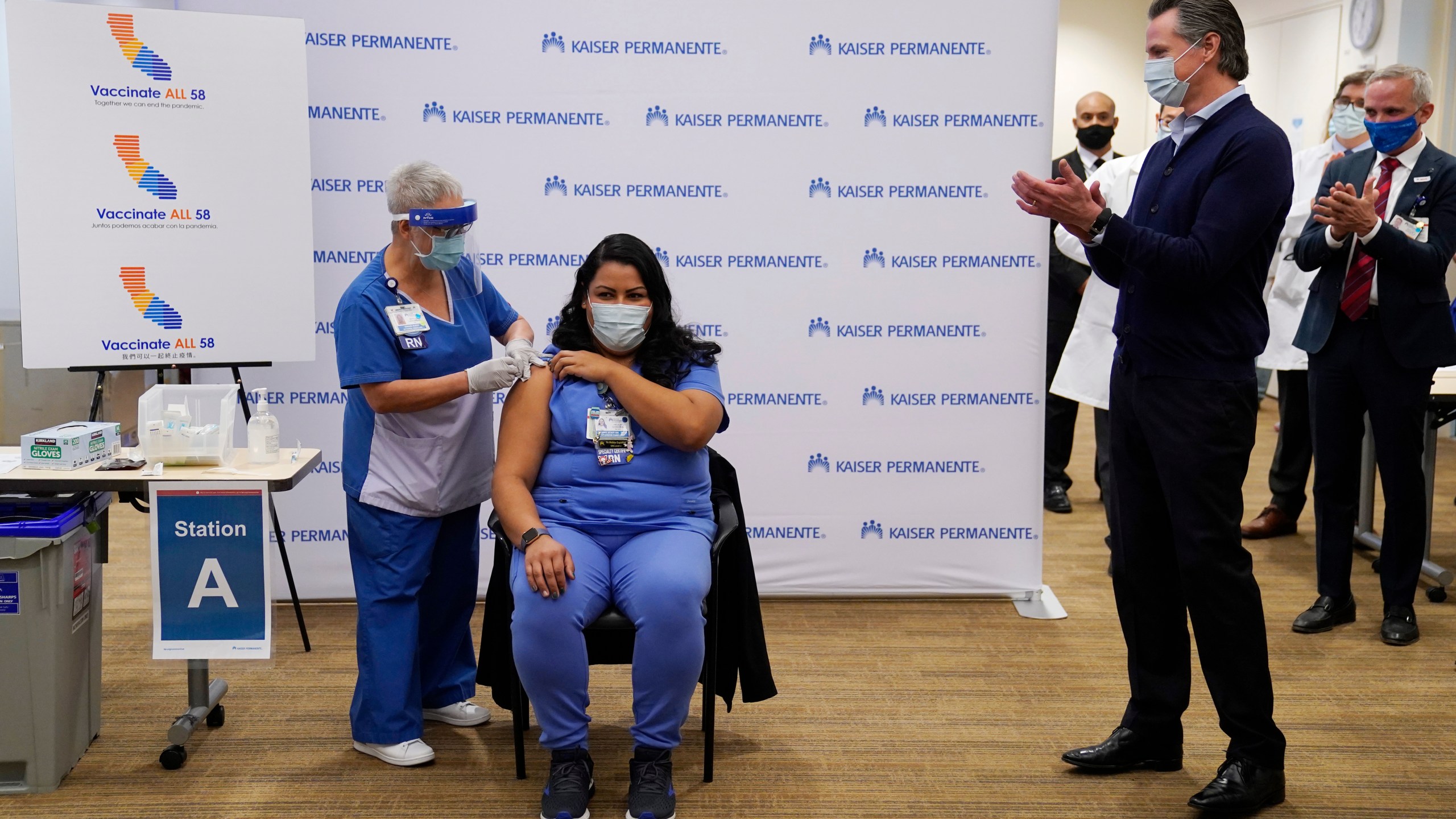 Gov. Gavin Newsom watches as ICU nurse Helen Cordova receives the Pfizer-BioNTech COVID-19 vaccine at Kaiser Permanente Los Angeles Medical Center on Dec. 14, 2020. (Jae C. Hong-Pool/Getty Images)