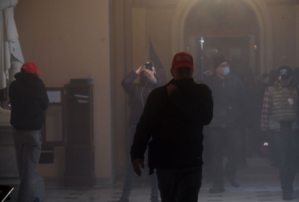 Supporters of President Donald Trump enter the US Capitol as tear gas fills the corridor on January 6, 2021, in Washington, DC. (Saul LOEB / AFP) (Photo by SAUL LOEB/AFP via Getty Images)