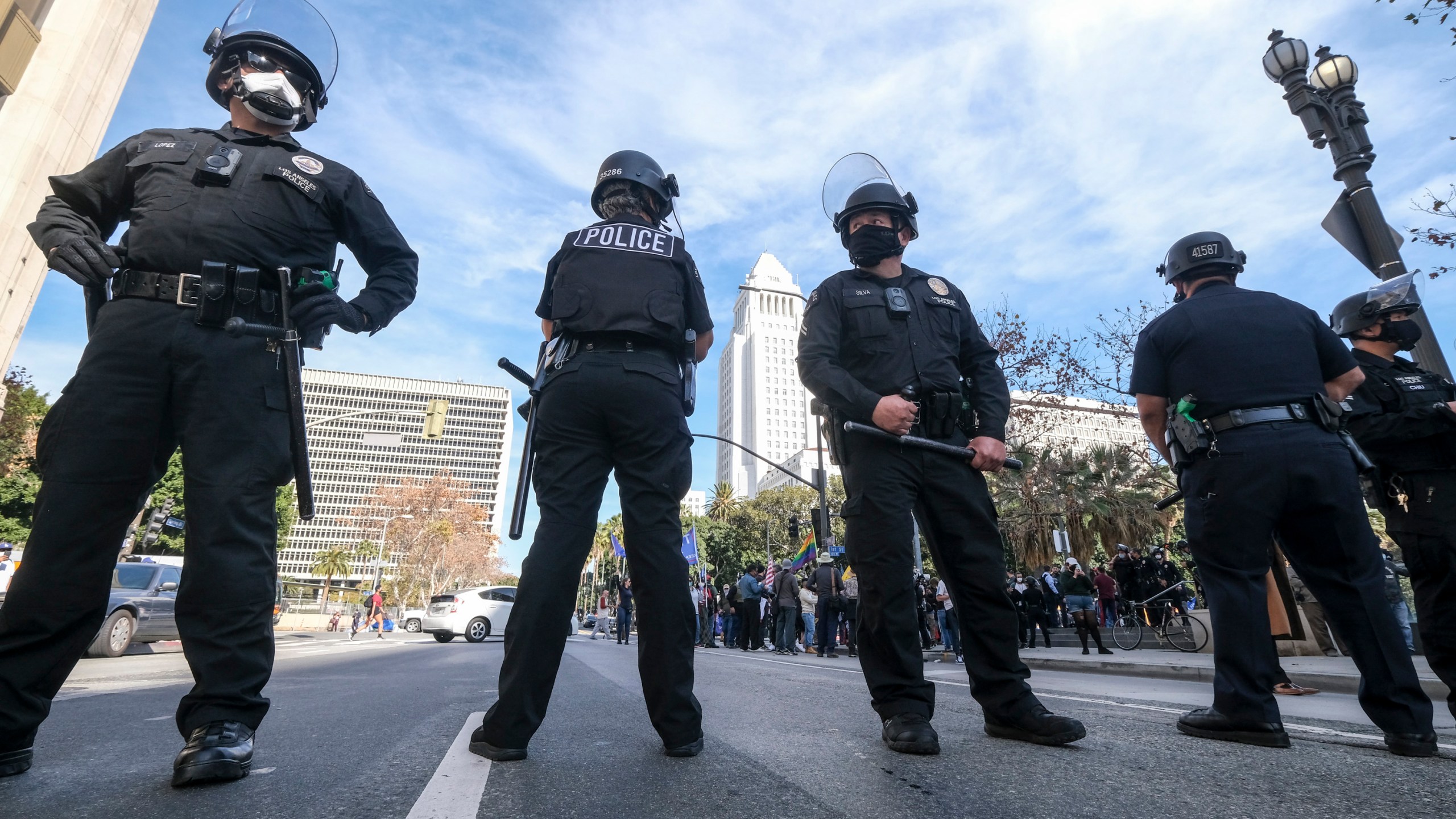 Police officers stand guard during a protest in support of President Donald Trump in Los Angeles on Jan. 6, 2021, the same day the U.S. Capitol was stormed. (Ringo Chiu / AFP / Getty Images)