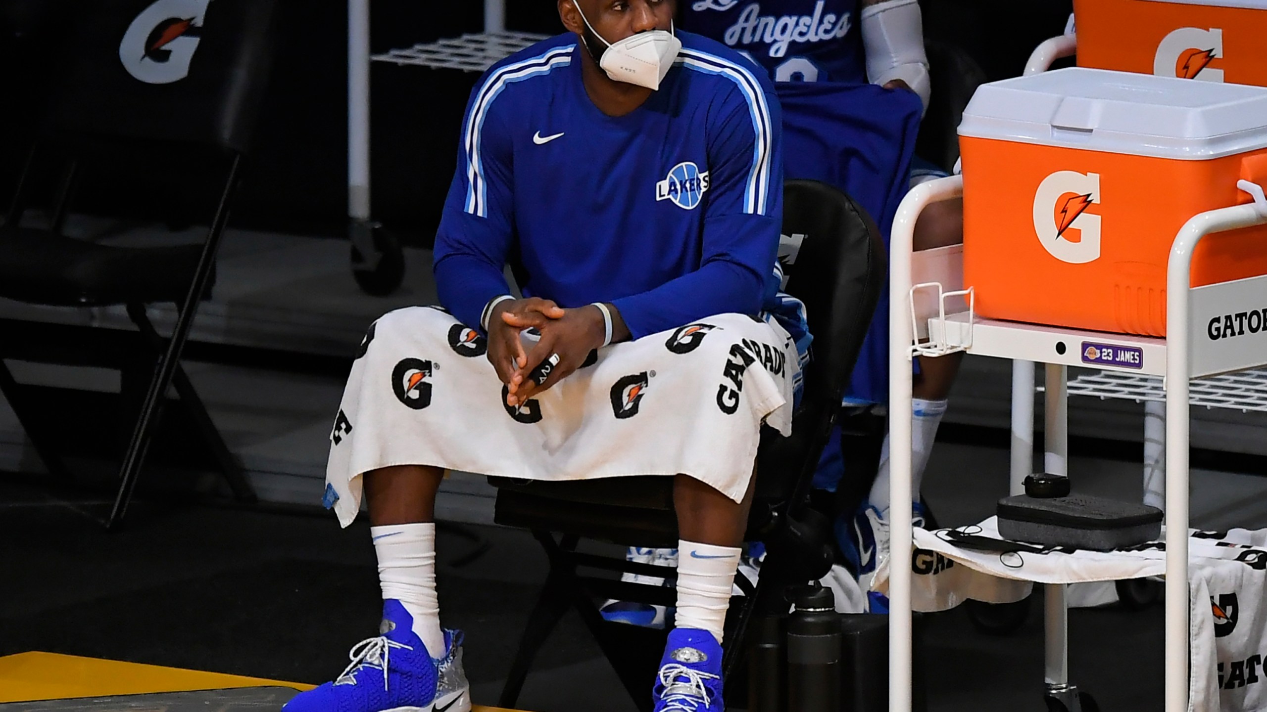 LeBron James #23 of the Los Angeles Lakers wears a face mask on the bench in a game against the Minnesota Timberwolves at Staples Center on December 27, 2020 in Los Angeles, California. (Photo by John McCoy/Getty Images)