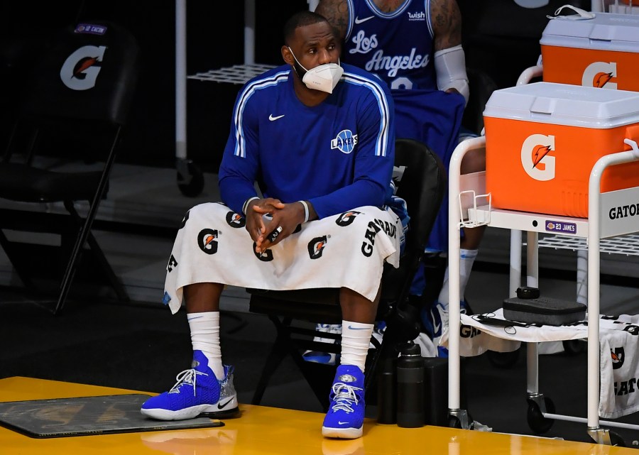 LeBron James #23 of the Los Angeles Lakers wears a face mask on the bench in a game against the Minnesota Timberwolves at Staples Center on December 27, 2020 in Los Angeles, California. (Photo by John McCoy/Getty Images)